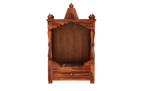 Wooden wardrobe with intricate carvings on a white background